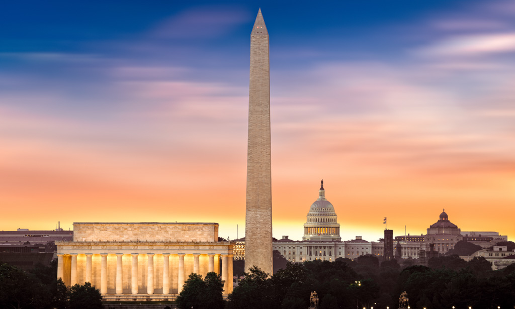 New Dawn over Washington - with 3 iconic monuments illuminated at sunrise: Lincoln Memorial, Washington Monument and the Capitol Building.