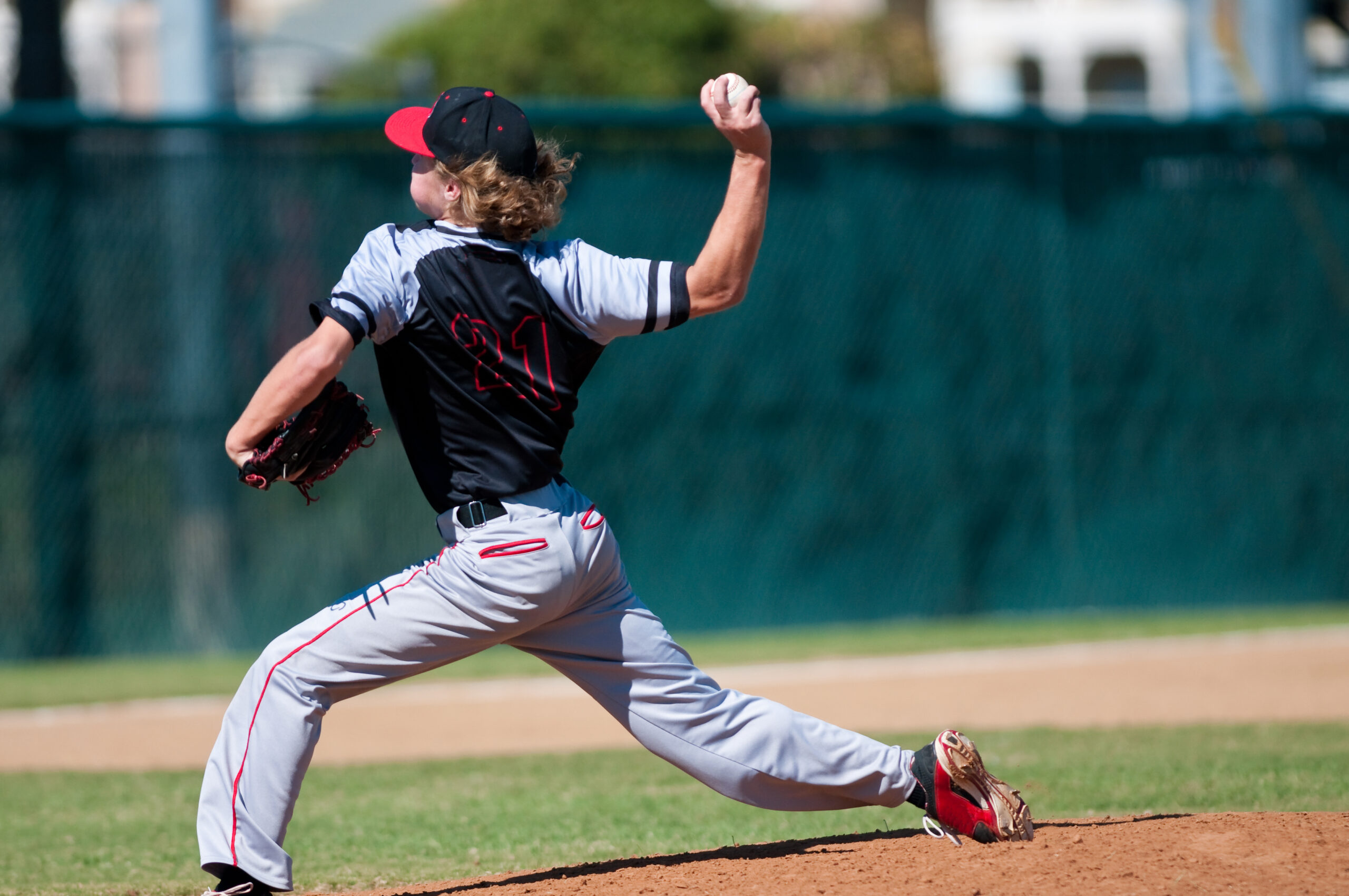 American teenage high school pitcher on the mound during a game.