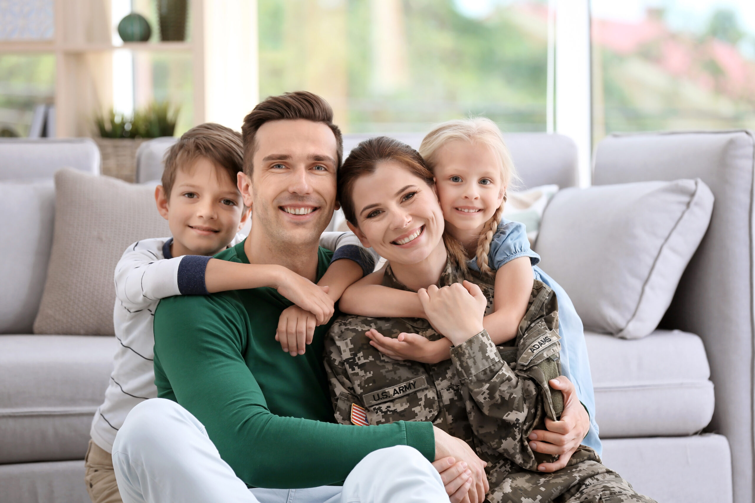 Woman in military uniform with her family at home