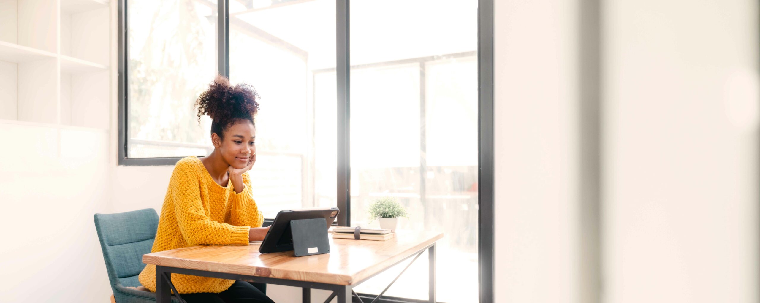 smiling woman working on an iPad