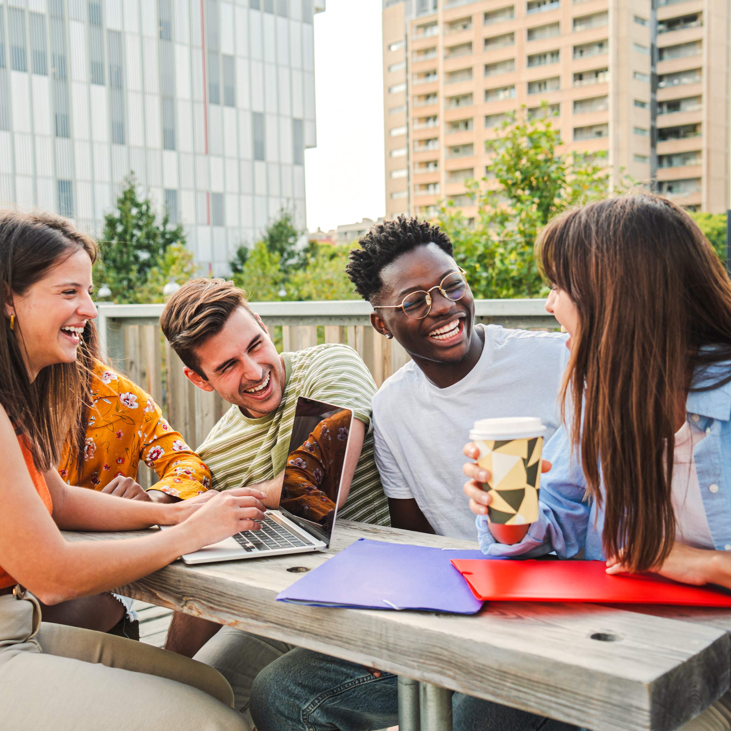 students laughing together on a rooftop