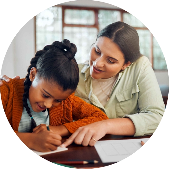 Mom helping girl student at desk